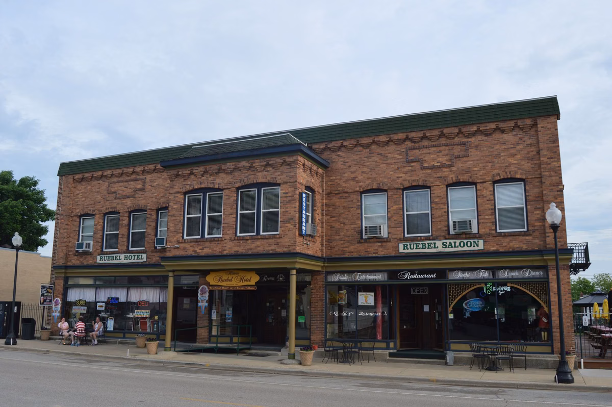 A two-story historic brick hotel building with storefronts on Main Street in Grafton, Illinois